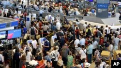 Passengers line up at check-in counter for Delta Air Lines at Narita international airport in Narita, east of Tokyo, Aug. 9, 2016. 