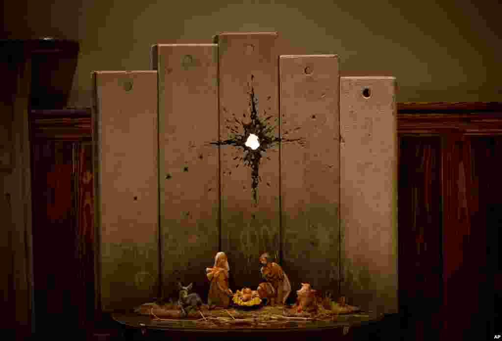 A new artwork dubbed &quot;Scar of Bethlehem&quot; by the artist Banksy is displayed in The Walled Off Hotel, in the West Bank city of Bethlehem.