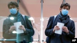 Christian Drosten, director of the Institute of Virology at Charité University Hospital in Berlin, is reflected in a glass as he leaves a news conference, amid the spread of the coronavirus disease, in Berlin, Germany, Jan. 22, 2021.