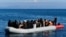 FILE - A Greek coast guard boat intercepts a dinghy with migrants near the Greek island of Lesbos, after it crossed the Aegean Sea from Turkey, March 1, 2020.