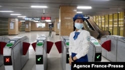 An attendant stands near turnstiles at Lang station in Hanoi, Vietnam, Nov. 6, 2021, on opening day of the city's first urban metro train running along the Cat Linh-Ha Dong line. (Photo by Nhac NGUYEN / AFP)