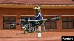 Lonh Vannsith, a fourth-year student of the National Polytechnic Institute of Cambodia, flies his team's drone in Phnom Penh, Cambodia, on September 17, 2021. REUTERS/Cindy Liu