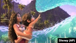 This image released by Disney shows the characters Moana, voiced by Auli'i Cravalho, holding Simea, voiced by Khaleesi Lambert-Tsuda, in a scene from "Moana 2."