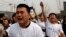 Family members of passengers of Malaysia Airlines flight MH370 cry as they shout slogans during a protest in front of the Malaysian embassy in Beijing March 25, 2014.