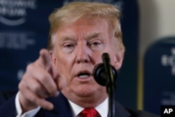 In this Jan. 22, 2020 photo, President Donald Trump speaks during a news conference at the World Economic Forum in Davos, Switzerland. T