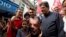 Workers' Party candidate for vice-president Fernando Haddad, 2nd from right, walks with a supporter who wears a shirt with a photo of former President Luiz Inacio Lula da Silva during a campaign rally in Rio de Janeiro, Brazil, Aug. 28, 2018. 