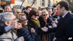 French president Emmanuel Macron meets residents as he walks to the city hall of Ajaccio, Feb. 6, 2018 in Corsica. Macron made a vibrant plea for the unity of the French Republic as he arrived Tuesday for a two-day visit.