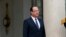 French President Francois Hollande stands outside the Elysee Palace as he waits for the arrival of a guest in Paris, May 7, 2013. 