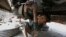 FILE - A 10-year-old boy works at an automotive repair shop in Lahore, Pakistan, to earn living for his family, June 12, 2021.