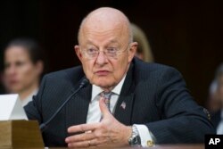 FILE— In this January 10, 2017 fphoto, then-National Intelligence Director James Clapper testifies on Capitol Hill in Washington.