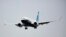 FILE - A Boeing 737 MAX airliner piloted by Federal Aviation Administration Administrator Steve Dickson lands following an evaluation flight at Boeing Field in Seattle, Sept. 30, 2020.