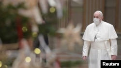 Pope Francis wears a protective mask before delivering his traditional Christmas Day Urbi et Orbi speech from inside the Hall of Blessings instead of from the St. Peter's square due to COVID-19 regulations, Vatican, Dec. 25, 2020.