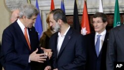 Menlu AS, John Kerry berbincang dengan Presiden Koalisi Nasional Suriah, Mouaz al-Khatib di dekat Menlu Turki Ahmet Davutoglu,dalam pertemuan Sahabat Suriah di Roma (28/2).