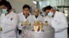 FILE - International Atomic Energy Agency inspectors and Iranian technicians prepare to cut the connections between the twin cascades for 20% uranium enrichment at the Natanz nuclear site near Natanz, Iran, Jan. 20, 2014.