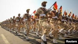 FILE - Members of the Iranian Revolutionary Guard march during a parade to commemorate the anniversary of the Iran-Iraq war (1980-88), in Tehran, Sept. 22, 2011. 