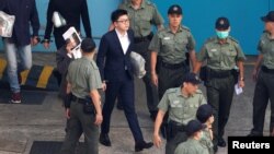 Pro-independence activist Edward Leung walks inside a detention center before leaving for the High Court for a sentencing hearing in Hong Kong, China, June 11, 2018.