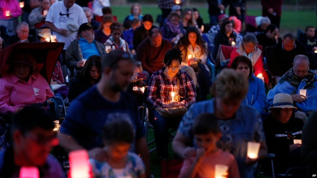 People attend a candle light vigil following a shooting at Umpqua Community College, Oct. 3, 2015, in Winston, Oregon.