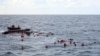 Refugees and migrants are rescued by members of the Spanish NGO Proactiva Open Arms, after leaving Libya trying to reach European soil aboard an overcrowded rubber boat in the Mediterranean sea, Nov. 11, 2020. 