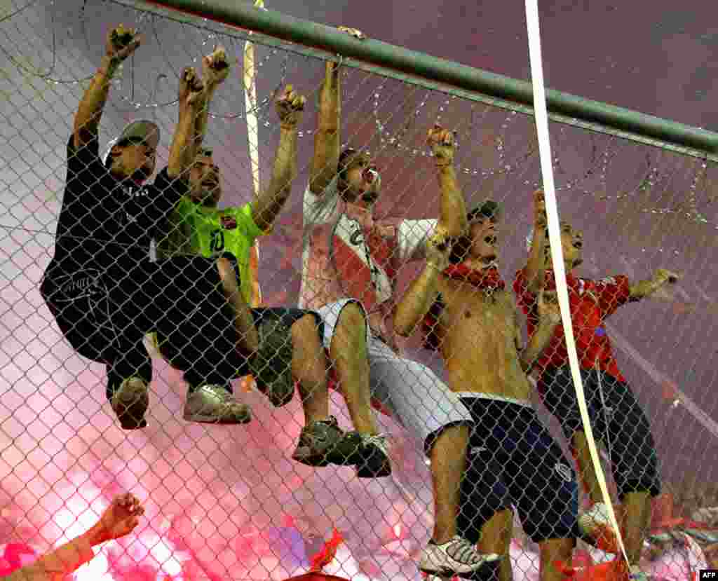 Fans of Argentina's Independiente cheer before their Copa Sudamericana final soccer match against Brazil's Goias, in Buenos Aires December 8. (Enrique Marcarian / Reuters)