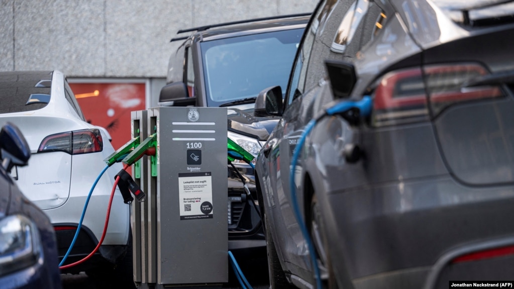 FILE: Electric cars are charged via a charging station on a street in the Norwegian capital Oslo on September 25, 2024. 