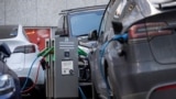 FILE: Electric cars are charged via a charging station on a street in the Norwegian capital Oslo on September 25, 2024. 