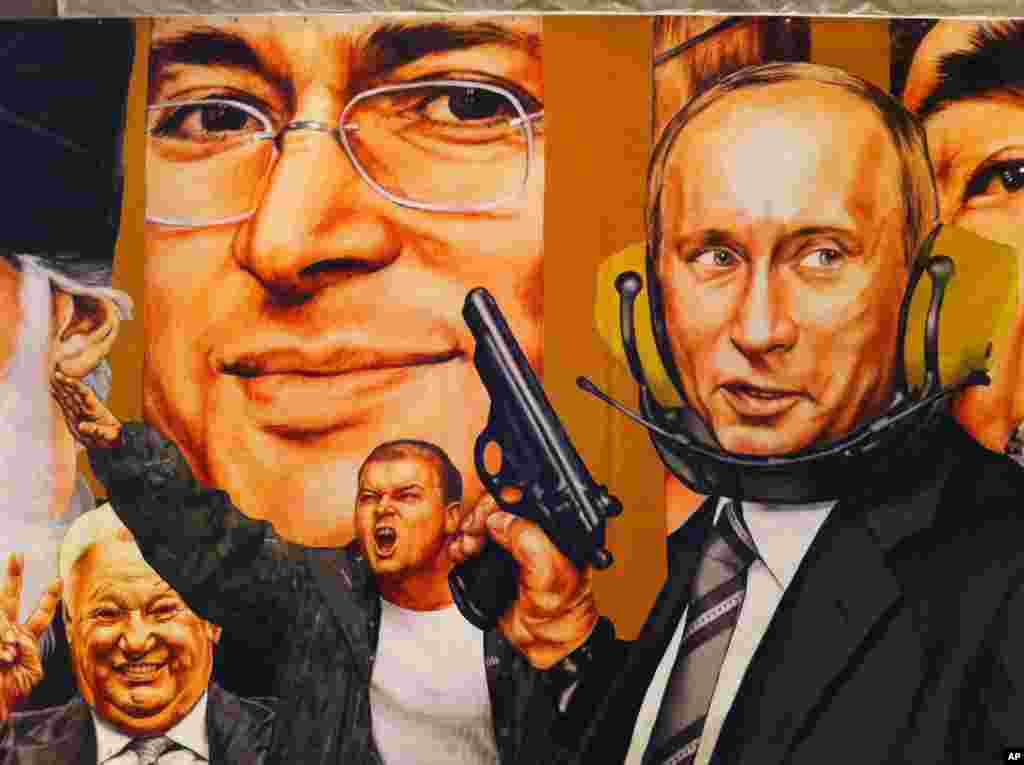 Vladimir Putin, the gunslinger, dominates a mural painted in 2007 by Dmitri Vrubel and Viktoria Timofeeva, showing the personalities of modern Russia. (VOA Photo/James Brooke)