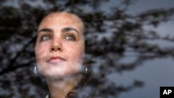 Peace Corps volunteer Kelsea Mensh, 22, poses inside the lobby of a Holiday Inn Express in Dumfries, Va., on April 1, 2020, her final day of a two-week quarantine.