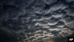 Sun sets behind a patterned cloud formed over the city in Kolkata, West Bengal state, India, Monday, May 18, 2020. A cyclonic storm 'Amphan' has intensified into a super cyclone.