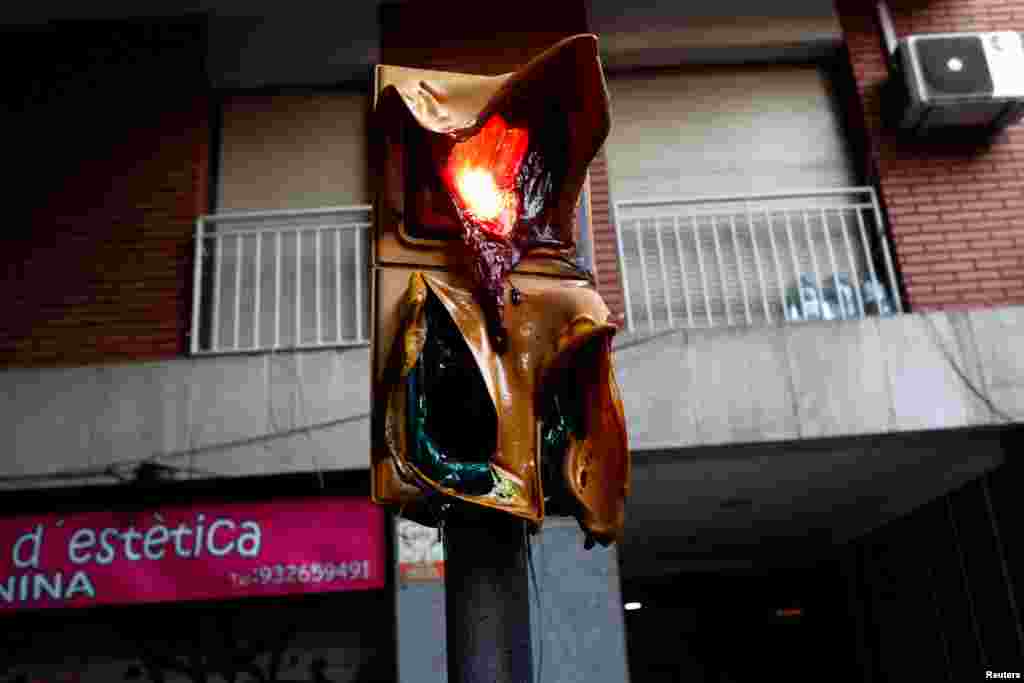 Melted traffic lights are seen after clashes of separatist demonstrators in Barcelona, Spain.