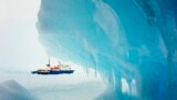 The MV Akademik Shokalskiy is seen stranded in ice in Antarctica, Dec. 29, 2013. An Antarctic blizzard has halted an Australian icebreaker&#39;s bid to reach a Russian ship trapped for a week with 74 people onboard, rescuers said.