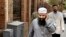 FILE - In this April 11, 2007 file photo, Egyptian cleric Osama Hassan Mustafa Nasr, also known as Abu Omar, who was allegedly kidnapped by CIA agents in an Italian city and taken to Egypt, talks on his mobile phone as he walks in a Cairo street.