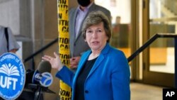 FILE - Randi Weingarten, president of the American Federation of Teachers, talks during a news conference in front of the Richard R. Green High School of Teaching, Sept. 8, 2020, in New York. 