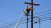 FILE - A man works on power lines in Los Angeles, California, May 4, 2020.