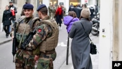 French army soldiers patrol near Rue des Rosiers street, in the heart of the Paris Jewish quarter, Monday Jan. 12, 2015. (AP Photo/Remy de la Mauviniere)