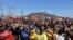 Miners gesture as they pray during the one-year anniversary commemorations to mark the killings of 34 striking platinum miners fatally shot by police outside the Lonmin's Marikana platinum mine in Rustenburg, 100 kilometers northwest of Johannesburg, Aug.