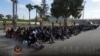 Soldiers stand next to detained migrants in Tripoli, Libya, in this photo released on Nov. 25, 2024. (Libyan Army 444th Combat Brigade/Handout via Reuters)