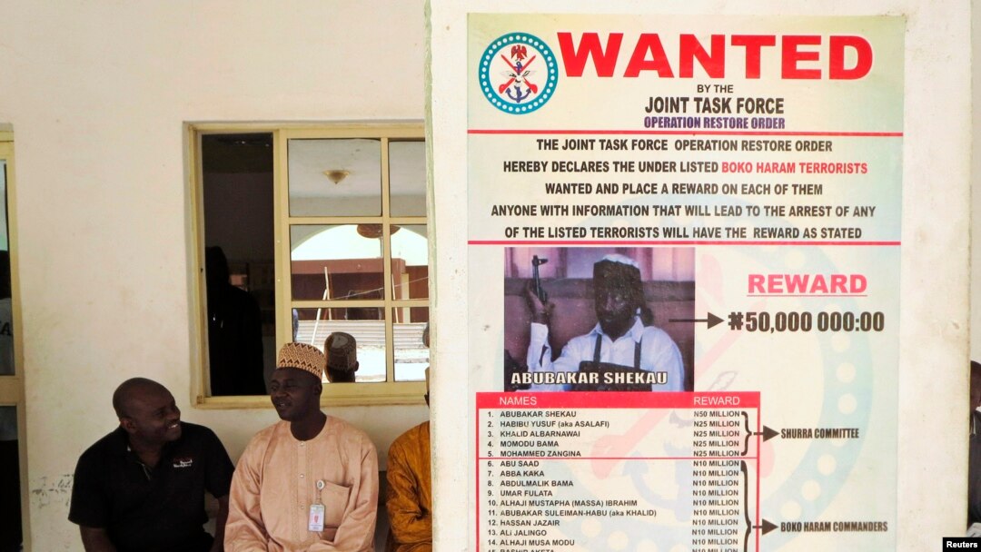 FILE - A poster advertising for the search of a Boko Haram leader is pasted on a wall in Baga village in Nigeria's northeastern Borno state, May 13, 2013.