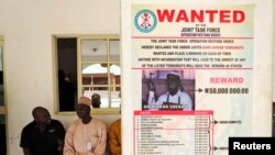 FILE - A poster advertising for the search of a Boko Haram leader is pasted on a wall in Baga village in Nigeria's northeastern Borno state, May 13, 2013.