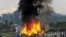 Nepalese gather around the burning wreckage at the crash site of a Sita Air airplane near Katmandu, Nepal, September 28, 2012.