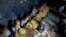 Children eat a meal at a school in a shanty neighborhood of New Delhi, India, Sept. 13, 2012.