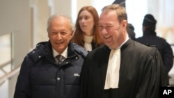 Thierry Gaubert, left, a former close adviser to former French President Nicolas Sarkozy arrives at the courtroom as Sarkozy goes on trial over alleged illegal financing of his 2007 presidential campaign, Jan. 6, 2025 in Paris.