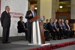 Carlos Slim speaks as Mexico's President Andres Manuel Lopez Obrador (L) looks on during an event where the government reached a deal with companies to renegotiate the terms of natural gas pipeline contracts in Mexico City, Aug. 27, 2019.