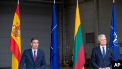 Lithuania's President Gitanas Nauseda, right, and Spain's Prime Minister Pedro Sanchez answers questions during a meeting with the press at Siauliai air force base, some 220 kms east of the capital Vilnius, Lithuania, July 8, 2021.