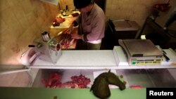 Charles Massa, a butcher, prepares horsemeat in his horse butchery shop, Nice, France, Feb. 14, 2013.