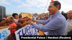 Peruvian President Martin Vizcarra visits flood victims in the northern city of Piura, Peru, March 27, 2018. 