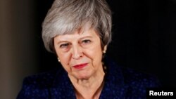 Britain's Prime Minister Theresa May speaks outside 10 Downing Street after a confidence vote by Conservative Party Members of Parliament (MPs), in London, Britain, Dec. 12, 2018.