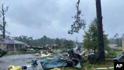 This photo provided by Alicia Jossey shows debris covering the street in East Brewton, Alabama, June 19, 2021.