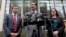 Attorney General Bob Ferguson, center, stands with Solicitor General Noah Purcell, left, and Civil Rights Unit Chief Colleen Melody as he speaks with media members on the steps of the federal courthouse after an immigration hearing there, March 15, 2017, 