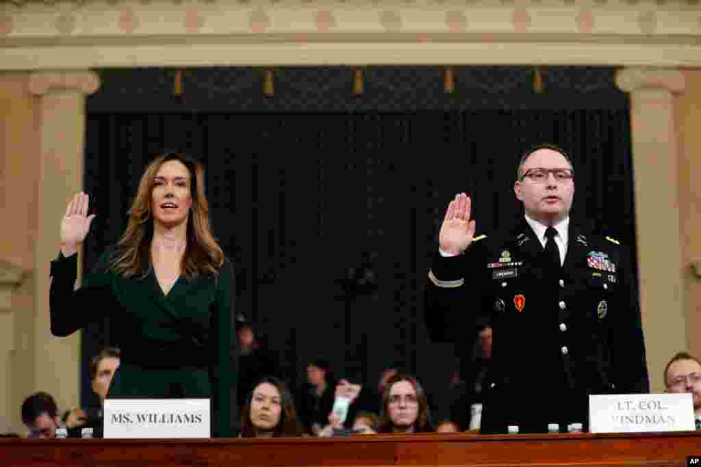 Jennifer Williams, an aide to Vice President Mike Pence, left, and National Security Council aide Lt. Col. Alexander Vindman, are sworn in to testify before the House Intelligence Committee on Capitol Hill in Washington, Nov. 19, 2019.