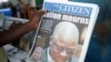 A man holds a newspapers following the death of Tanzania's President John Magufuli in Dar es Salaam, Tanzania, March 18, 2021.